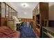Basement featuring blue carpet, wooden shelves and a cozy reading nook at 1377 Tucker Woods Dr, Norcross, GA 30093