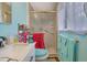 Bathroom featuring shower, tiled walls, and modern sink with storage at 1377 Tucker Woods Dr, Norcross, GA 30093