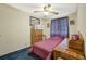 Bedroom showing neutral walls, blue carpet, and twin bed by window at 1377 Tucker Woods Dr, Norcross, GA 30093
