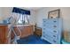 Comfortable bedroom displaying blue carpet, vintage furniture, and natural light at 1377 Tucker Woods Dr, Norcross, GA 30093