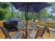 Outdoor deck features a dining table with umbrella and a grill, perfect for enjoying meals outdoors at 1377 Tucker Woods Dr, Norcross, GA 30093