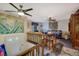 Inviting living room featuring ceiling fans, blue carpet, and vibrant floral art at 1377 Tucker Woods Dr, Norcross, GA 30093