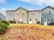 A big backyard with a small patio area, and beige and blue sidings on the townhomes at 2138 Chadwick Sw Rd, Atlanta, GA 30331