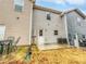 The backyard has a patio area, with beige and blue sidings on the townhomes at 2138 Chadwick Sw Rd, Atlanta, GA 30331
