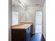 Bright bathroom featuring a large mirror, dark cabinets, and sleek fixtures at 2138 Chadwick Sw Rd, Atlanta, GA 30331