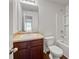 Cozy bathroom with a dark vanity, toilet, and shower-tub combination at 2138 Chadwick Sw Rd, Atlanta, GA 30331