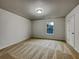 Bright, vacant bedroom with neutral walls, carpet, and a window at 2138 Chadwick Sw Rd, Atlanta, GA 30331