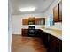 Well-lit kitchen with brown cabinets, black appliances, and granite countertops at 2138 Chadwick Sw Rd, Atlanta, GA 30331