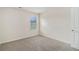 This bedroom features neutral walls, carpet, and a window providing natural light at 255 Orchard Dr, Covington, GA 30014