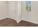Bright entryway with hardwood floors, a window, and a white front door at 255 Orchard Dr, Covington, GA 30014