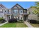 Charming townhome featuring stone accents, a well-manicured lawn, and a welcoming entrance at 255 Orchard Dr, Covington, GA 30014