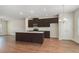 Modern kitchen featuring a central island, stainless steel appliances, and hardwood floors at 255 Orchard Dr, Covington, GA 30014