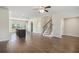Open-concept living room featuring hardwood floors, recessed lighting, and staircase at 255 Orchard Dr, Covington, GA 30014