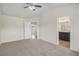 Spacious main bedroom with vaulted ceiling, ensuite bathroom, and neutral carpet at 255 Orchard Dr, Covington, GA 30014