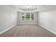 Spacious bedroom with three windows, neutral paint, and tray ceilings at 2721 Grapevine Cir # 1701, Cumming, GA 30041