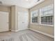 Bright bedroom features neutral carpeting, two windows, and a double door closet at 2721 Grapevine Cir # 1701, Cumming, GA 30041