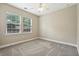 Neutral bedroom featuring two sunny windows and a ceiling fan at 2721 Grapevine Cir # 1701, Cumming, GA 30041