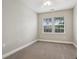 Bedroom featuring neutral paint, carpet, and windows for natural light at 2721 Grapevine Cir # 1701, Cumming, GA 30041