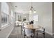 Dining area that is virtually staged with natural light and stylish furniture at 2721 Grapevine Cir # 1701, Cumming, GA 30041