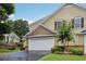 Exterior view of a home featuring a two-car garage, manicured lawn, and traditional architecture at 2721 Grapevine Cir # 1701, Cumming, GA 30041