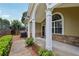 Inviting front porch with white pillars, arched window, and brick accents at 2721 Grapevine Cir # 1701, Cumming, GA 30041