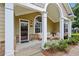 Inviting front porch with ample seating, elegant columns, and stylish decor at 2721 Grapevine Cir # 1701, Cumming, GA 30041