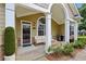 Inviting front porch with a seating area, a grill, and mature landscaping with brick accents at 2721 Grapevine Cir # 1701, Cumming, GA 30041