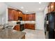 Well-equipped kitchen with tile backsplash, cherry cabinets and stainless steel appliances at 2721 Grapevine Cir # 1701, Cumming, GA 30041