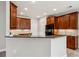 Kitchen featuring granite countertops, cherry cabinets, and modern appliances at 2721 Grapevine Cir # 1701, Cumming, GA 30041