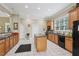 Community kitchen features a large island, sleek black appliances, and ample counter space at 2721 Grapevine Cir # 1701, Cumming, GA 30041
