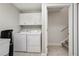 Well-equipped laundry room featuring a washer, dryer, and storage cabinets for added convenience at 2721 Grapevine Cir # 1701, Cumming, GA 30041