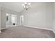 Bright living room featuring vaulted ceilings, gray carpeting, and modern chandelier at 2721 Grapevine Cir # 1701, Cumming, GA 30041