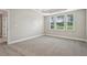 Spacious main bedroom featuring tray ceilings and a scenic view from the three windows at 2721 Grapevine Cir # 1701, Cumming, GA 30041