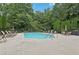 Community pool with lounge chairs and tables for outdoor relaxation and entertainment at 2721 Grapevine Cir # 1701, Cumming, GA 30041