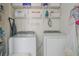 Functional laundry room showcasing modern washer and dryer with storage shelves and 'Lost Socks' sign at 4336 Thorngate Ln, Acworth, GA 30101