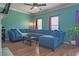 Inviting living room with a comfortable blue sectional and wood flooring at 4336 Thorngate Ln, Acworth, GA 30101