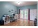 Bright office with French doors, a work space, white cabinets, and aqua walls at 4336 Thorngate Ln, Acworth, GA 30101