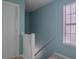 Well-lit stairway featuring a white banister and a window providing natural light and ventilation at 4336 Thorngate Ln, Acworth, GA 30101