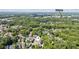 Aerial view displaying the property's setting near the Atlanta, surrounded by mature trees and other homes at 5971 Brundage Lane, Norcross, GA 30071