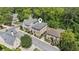 Aerial view of a brick home nestled among lush trees in a quiet residential neighborhood at 5971 Brundage Lane, Norcross, GA 30071