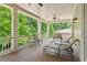 Inviting covered back porch with comfortable seating overlooking lush greenery at 5971 Brundage Lane, Norcross, GA 30071