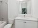 Modern bathroom with gray tiled shower and white vanity with mirror at 5971 Brundage Lane, Norcross, GA 30071
