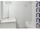 Bright bathroom featuring a modern vanity, tiled shower and tub combination and neutral color palette at 5971 Brundage Lane, Norcross, GA 30071