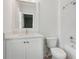 Bright bathroom featuring a white vanity, a mirror, a toilet and a shower with gray tiled walls at 5971 Brundage Lane, Norcross, GA 30071