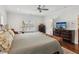 Bright bedroom featuring wood floors, a ceiling fan, and natural light from the window at 5971 Brundage Lane, Norcross, GA 30071