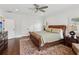 Relaxing bedroom with a ceiling fan, hardwood floors, and a patterned rug at 5971 Brundage Lane, Norcross, GA 30071