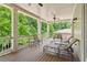 Spacious covered porch with chairs and loungers, perfect for outdoor relaxation and entertaining at 5971 Brundage Lane, Norcross, GA 30071