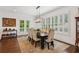 Dining area features a long wood table, stylish chairs, and shuttered windows at 5971 Brundage Lane, Norcross, GA 30071