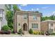 Elegant brick home featuring classic design elements such as an arched doorway and neat, green landscaping at 5971 Brundage Lane, Norcross, GA 30071