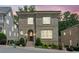 Charming two-story brick home with arched entry, manicured landscaping, and bright windows at dusk at 5971 Brundage Lane, Norcross, GA 30071
